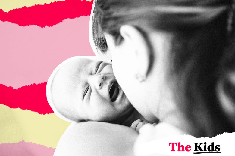 A baby cries in its mother’s arms.